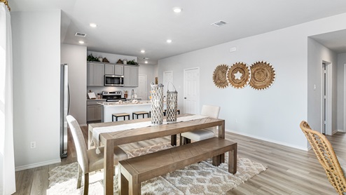 Mitchell Farm model home dining room with a view of the kitchen.