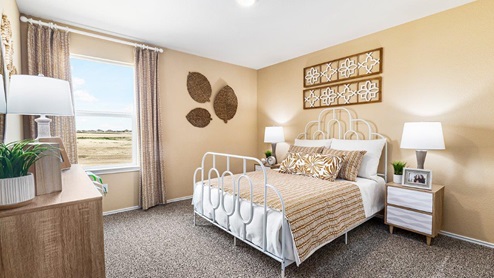 Mitchell Farm model home secondary bedroom with a full-size bed and carpet flooring.