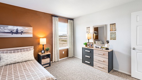 Mitchell Farm model home secondary bedroom with a twin bed and carpet flooring.