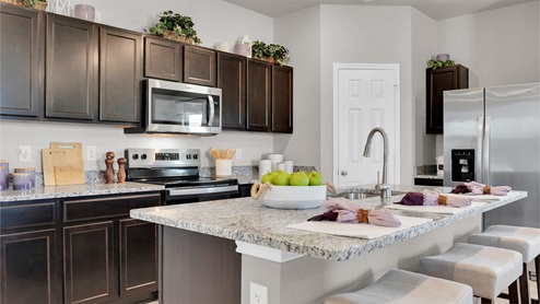 Reynolds Crossing kitchen with dark cabinets and granite countertops.