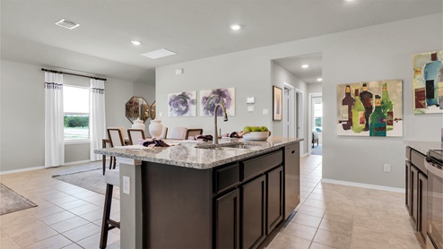 Reynolds Crossing kitchen with dark cabinets and granite countertops.