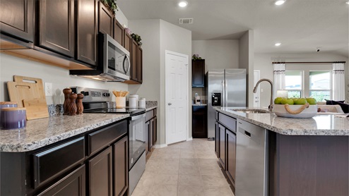 Reynolds Crossing kitchen with dark cabinets and granite countertops.