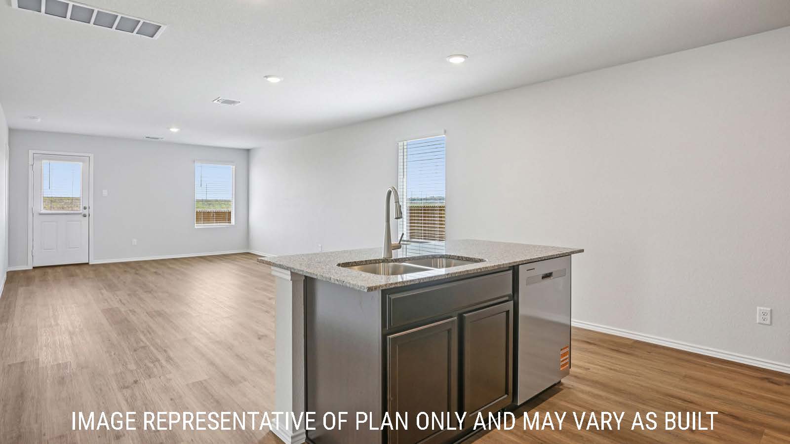 Barton kitchen with kitchen island and view of open concept dining room and living room.