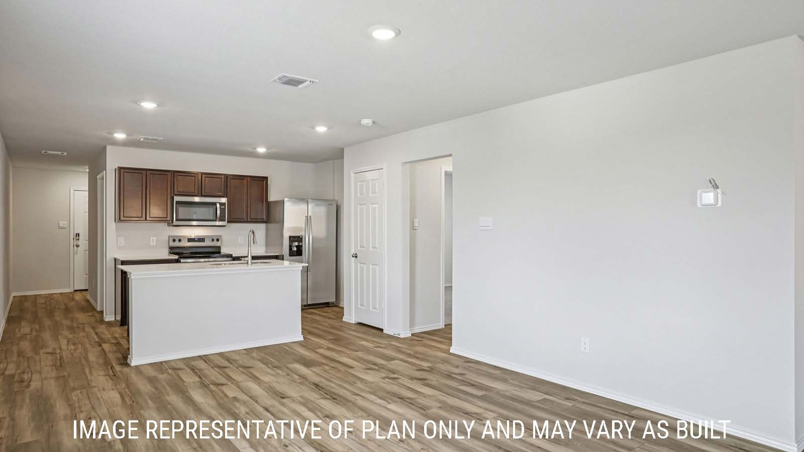 Caprock dining room with vinyl plank flooring and view of open concept kitchen.