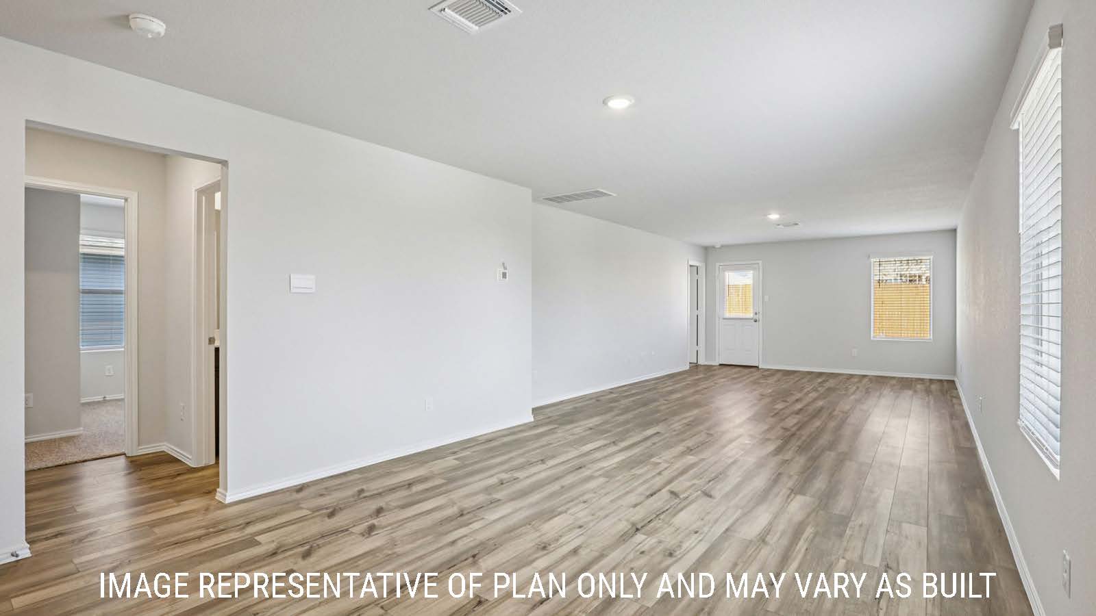 Caprock dining room with vinyl plank flooring and view of open concept living room.