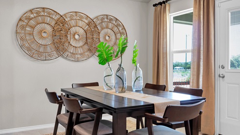 Victory Ranch model home dining room table and window with view to backyard.