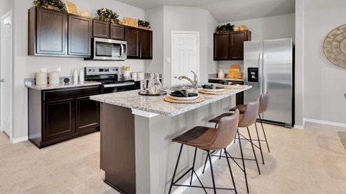 Victory Ranch model home kitchen featuring large kitchen island.