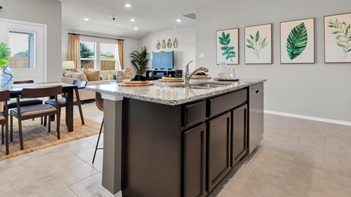 Victory Ranch model home kitchen featuring large kitchen island.