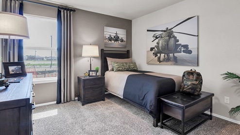 Victory Ranch secondary bedroom with carpet flooring and furniture and design accents.