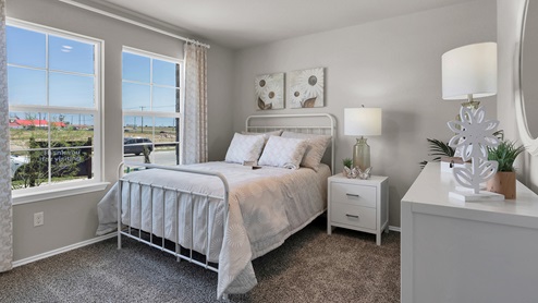 Victory Ranch secondary bedroom with carpet flooring and furniture and design accents.