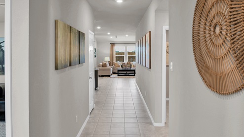 Victory Ranch model home entry hallway with tile flooring.
