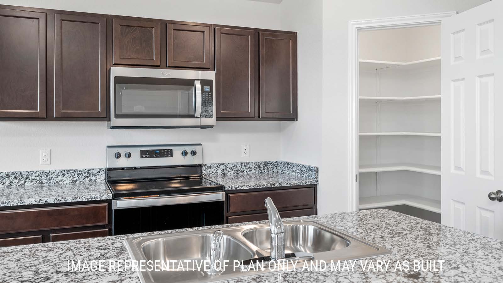 Ashburn kitchen with granite countertops with dark cabinets and a corner pantry.