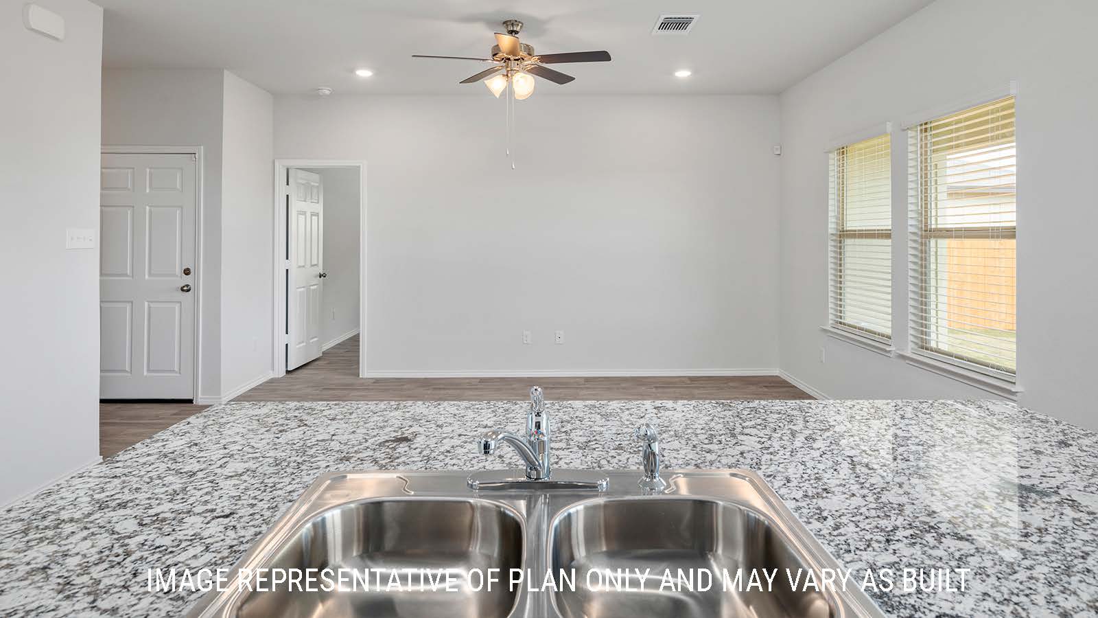 Ashburn kitchen with center kitchen island with granite countertops and view of living room.