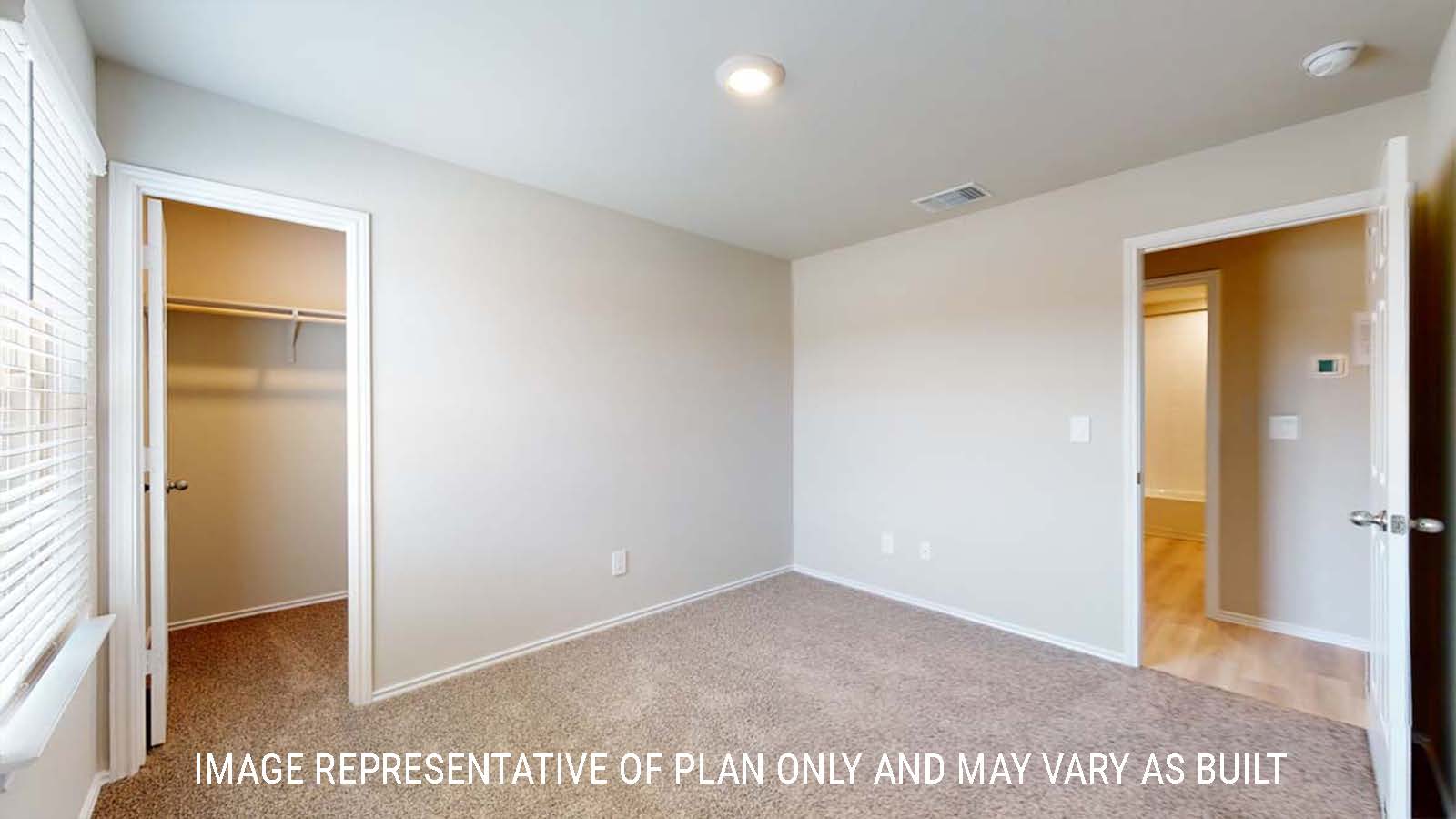 Bellvue secondary bedroom with closet and carpeted flooring.