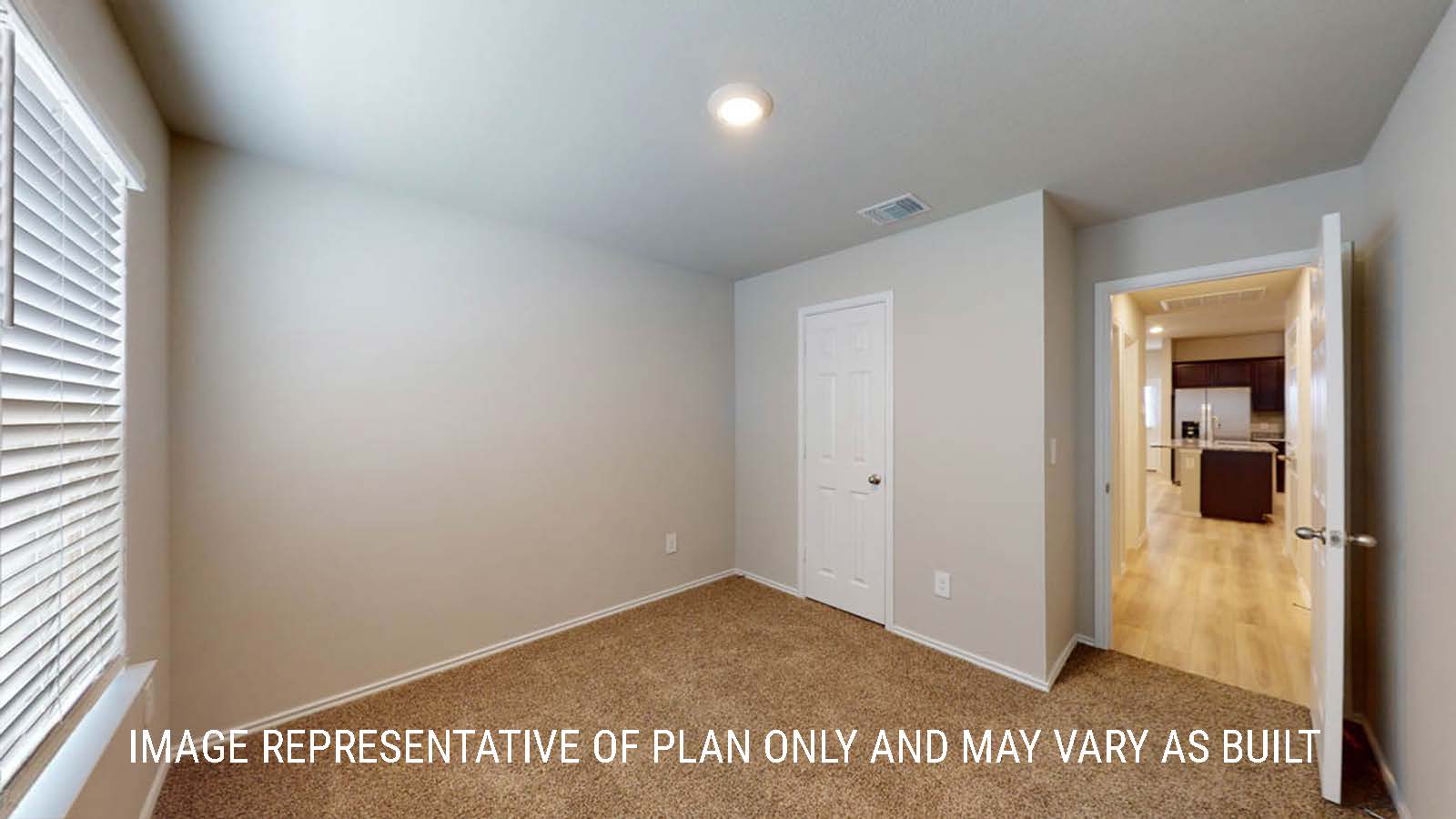 Camden secondary bedroom with closet and carpeted flooring.