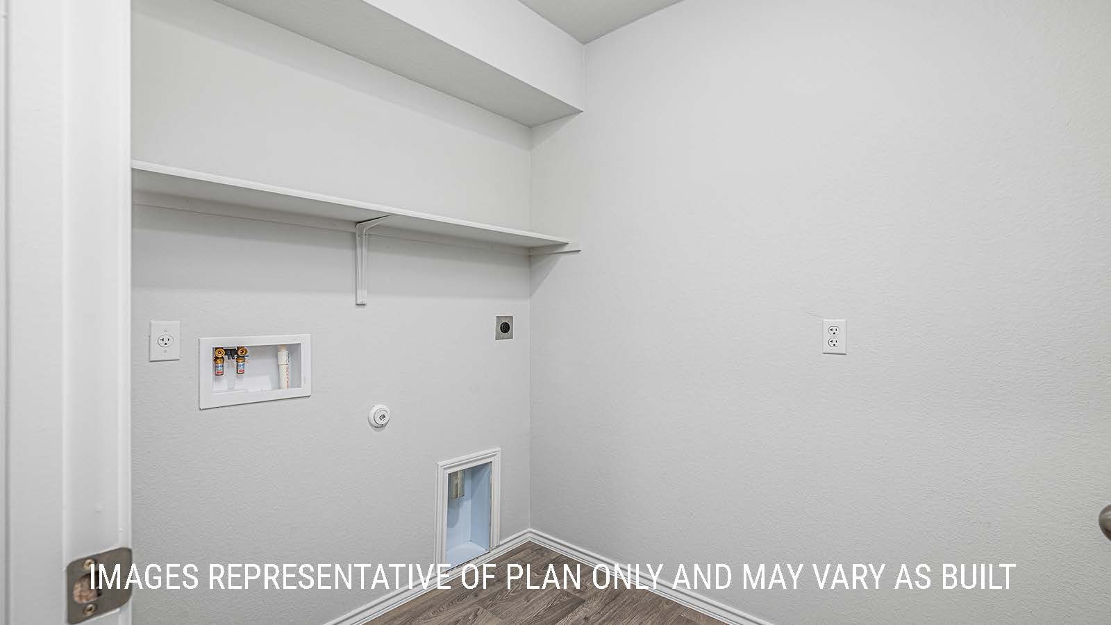 Elgin utility room with shelving and washer and dryer connections.