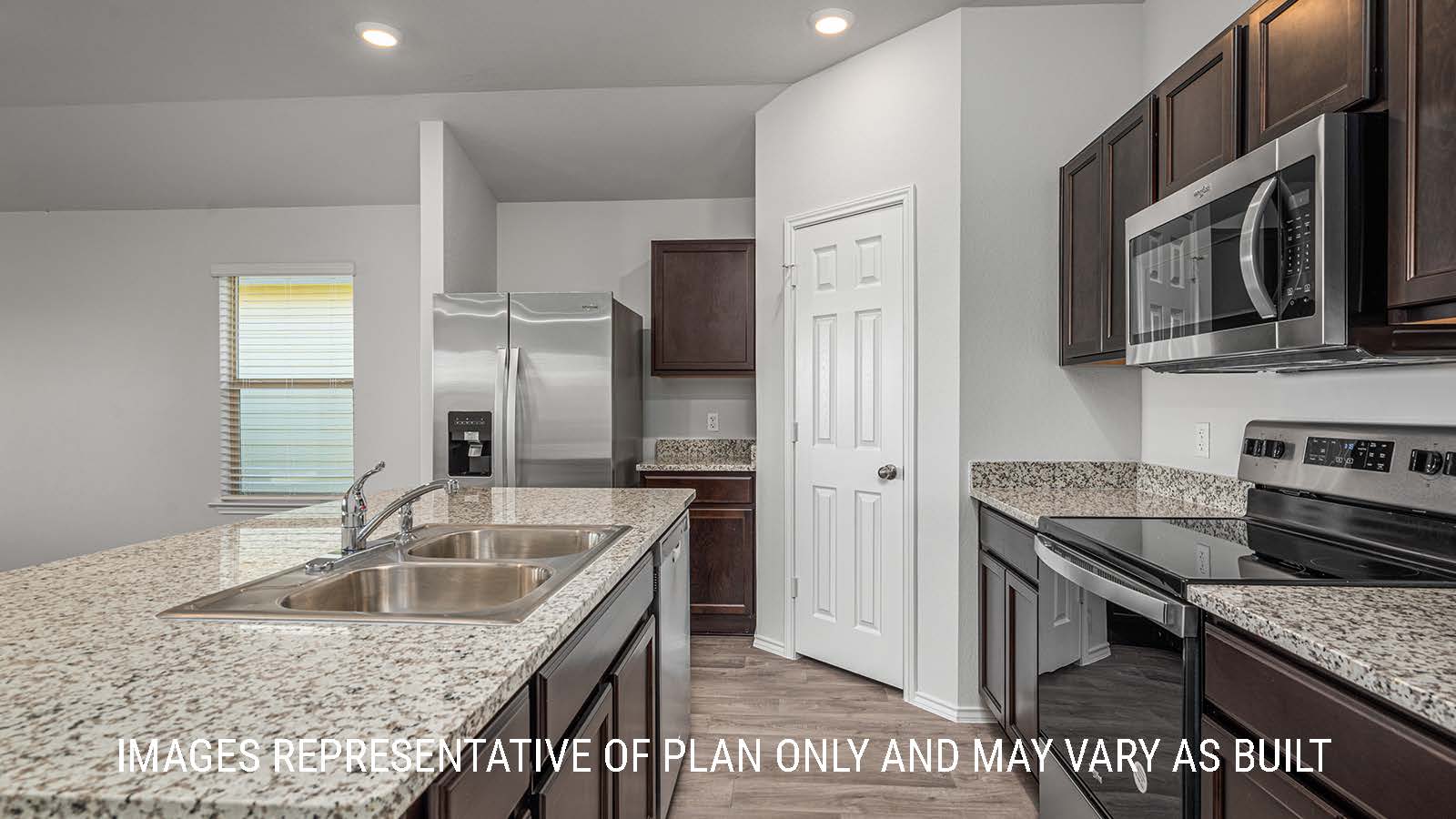 Elgin kitchen with granite countertops and dark cabinets.