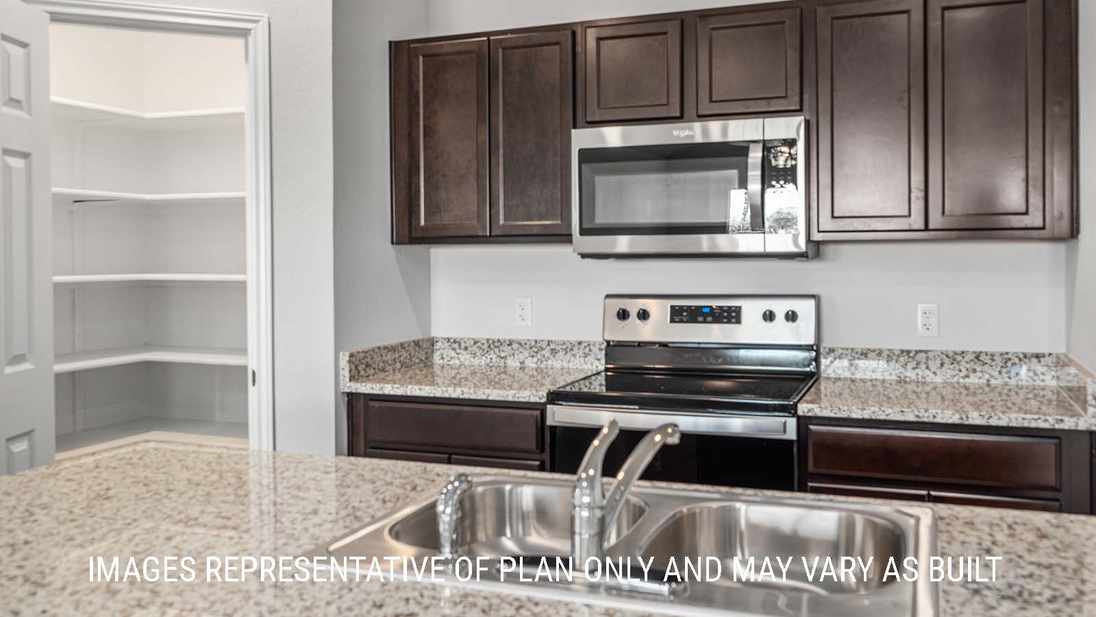 Elgin kitchen with granite countertops and dark cabinets.