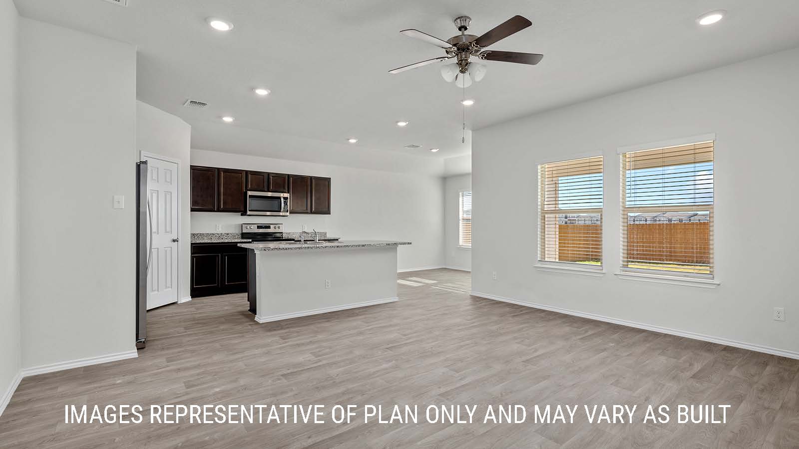 Fargo living room with vinyl plank flooring and view of the backyard.