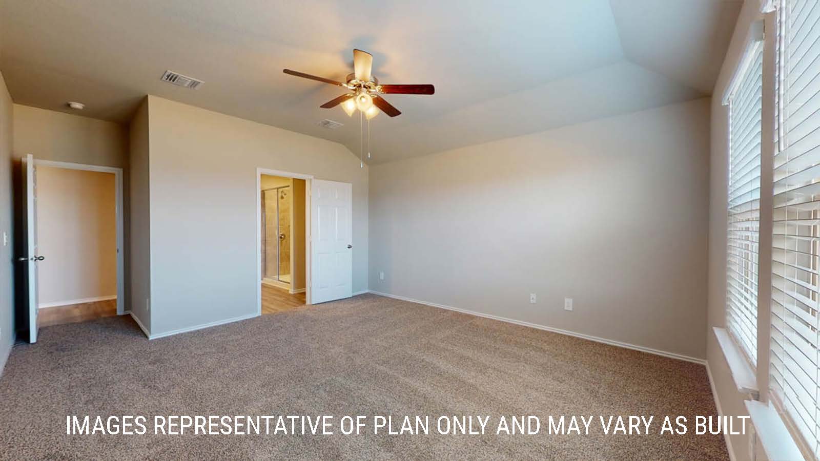 Fargo primary bedroom with carpeted flooring with view of primary bathroom.