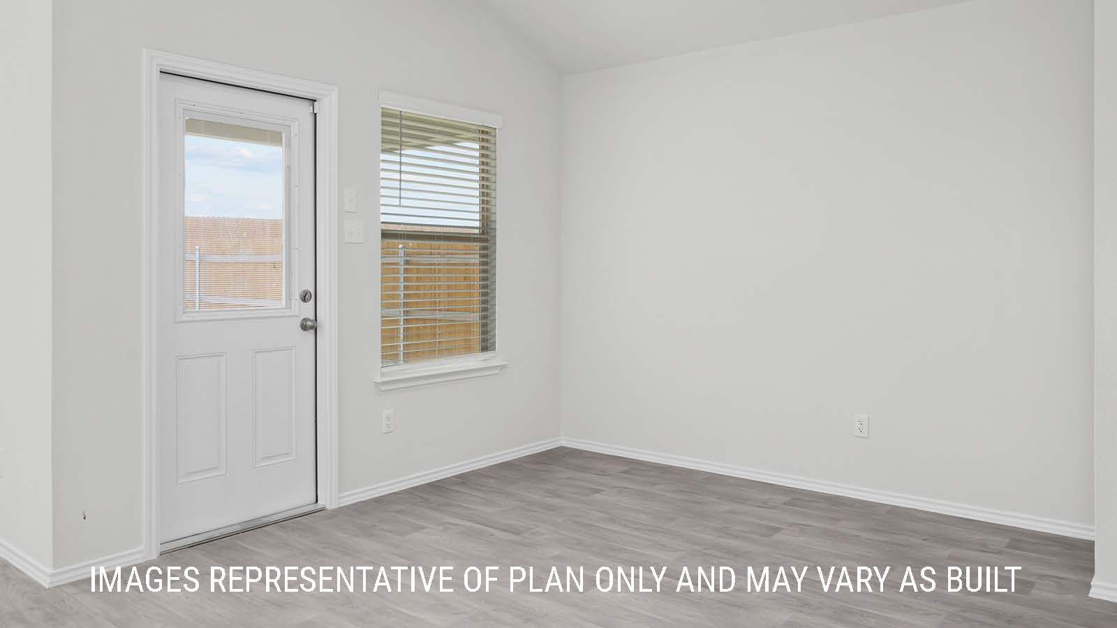 Texas Cali living room with vinyl plank flooring and windows with view of backyard.