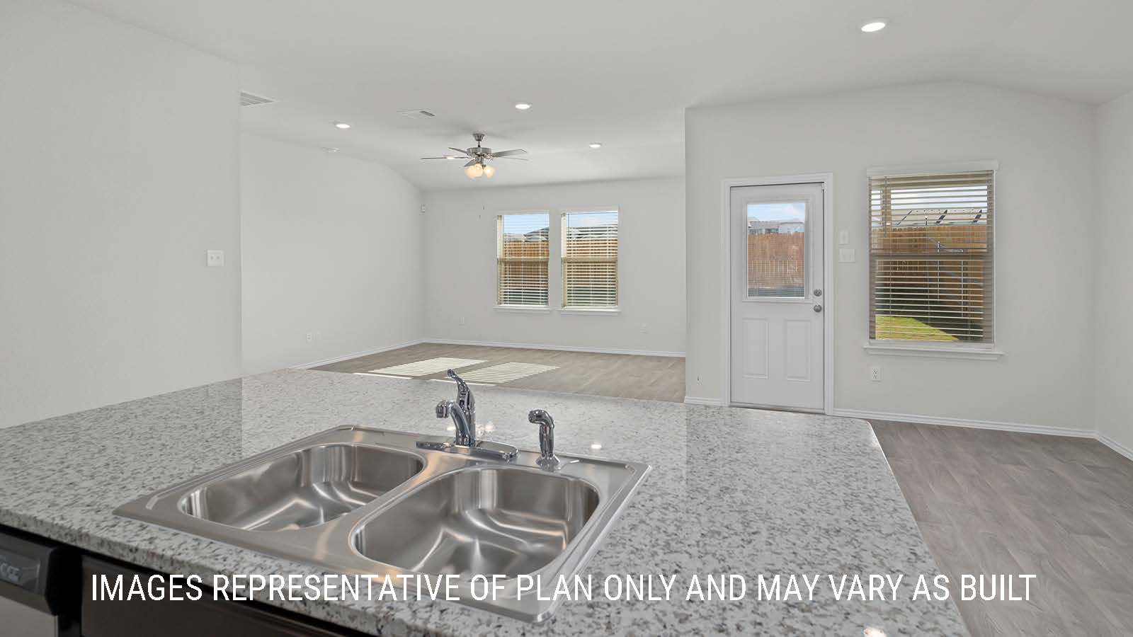 Texas Cali kitchen with kitchen center island and view of open conept living room and dining room.