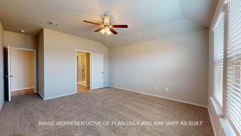 Fargo primary bedroom with carpet flooring and windows.