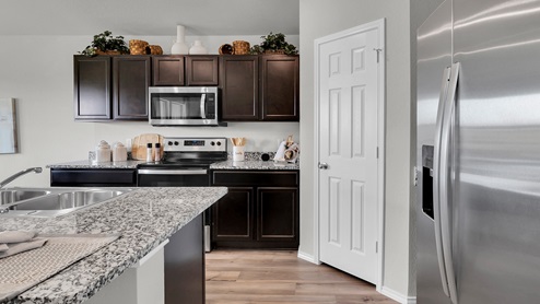West Canyon Trails Model Home Kitchen with dark cabinets and granite countertops