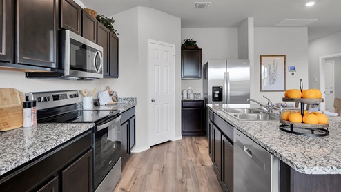 West Canyon Trails Model Home Kitchen with dark cabinets and granite countertops