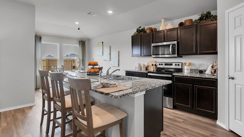 West Canyon Trails Model Home Kitchen with dark cabinets and granite countertops