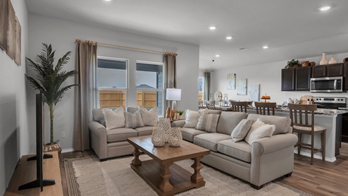 West Canyon Trails Model Home Living Room decorated with neutral furniture and windows