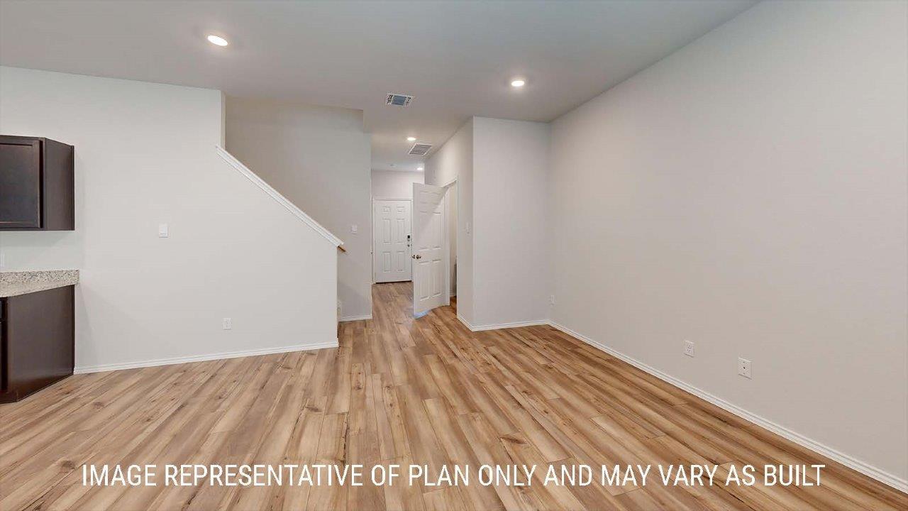 Emma entry with view of open concept living room and kitchen.