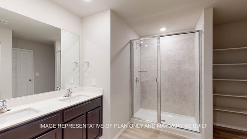Texas Cali primary bath with clear shower glass enclosure and ceramic tile surround in walk-in shower.