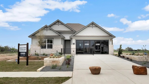Eastern Wells Model Home exterior with glass store front doors.