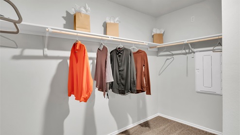 Eastern Wells Model Home primary closet with hanging rods and shelf.