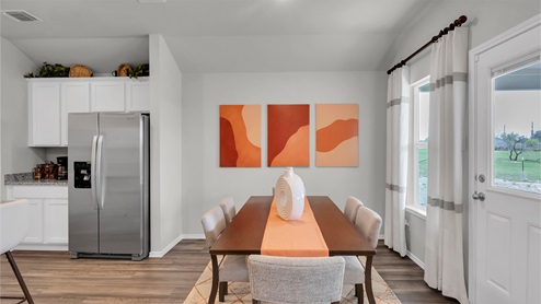 Eastern Wells Model Home dining room with dining table and chairs.