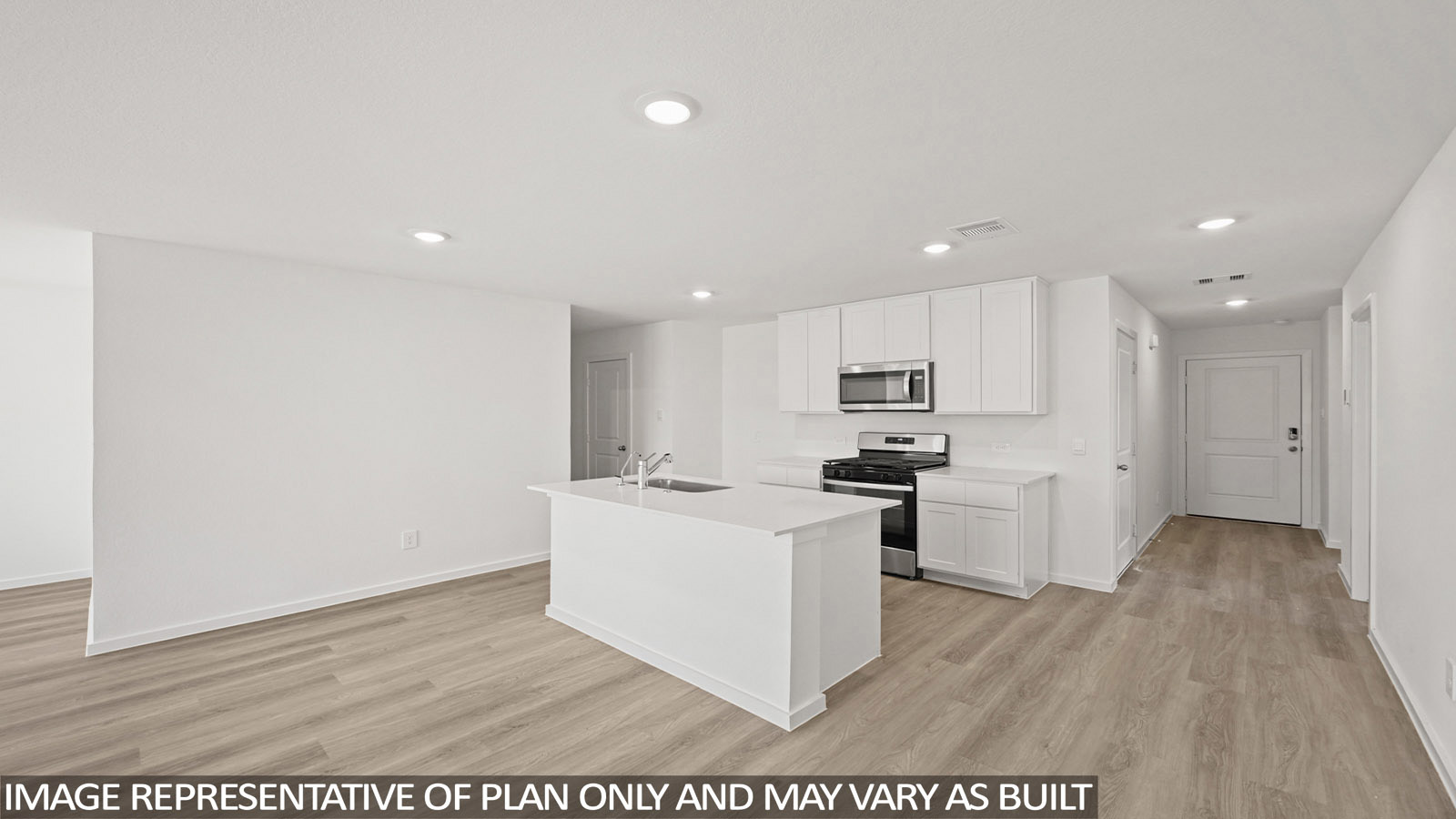 Archer kitchen with kitchen island and white cabinets and light countertops with view of entry way.