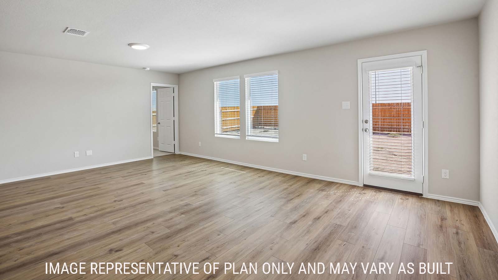 Archer dining room with view of open concept living room and windows for natural lighting.