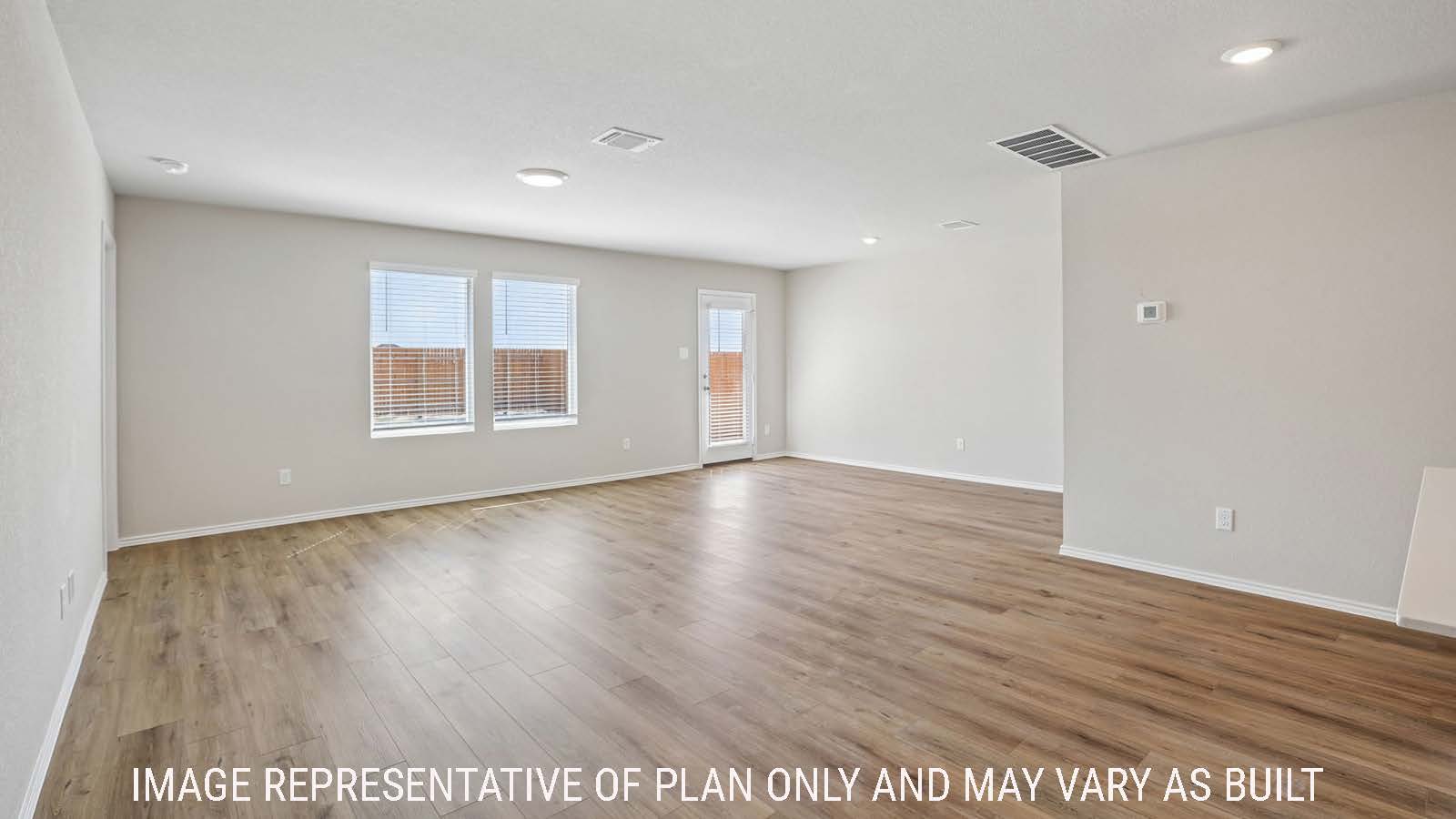 Archer living room with view of open concept dining room with windows for natural lighting.