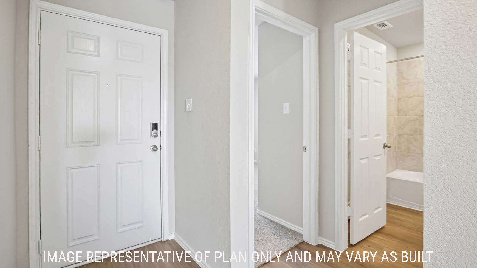 Archer entry hallway with view of front door and secondary bedroom and bathroom.