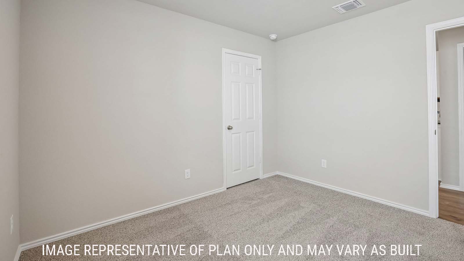 Archer secondary bedroom with carpeted flooring and view of hallway.
