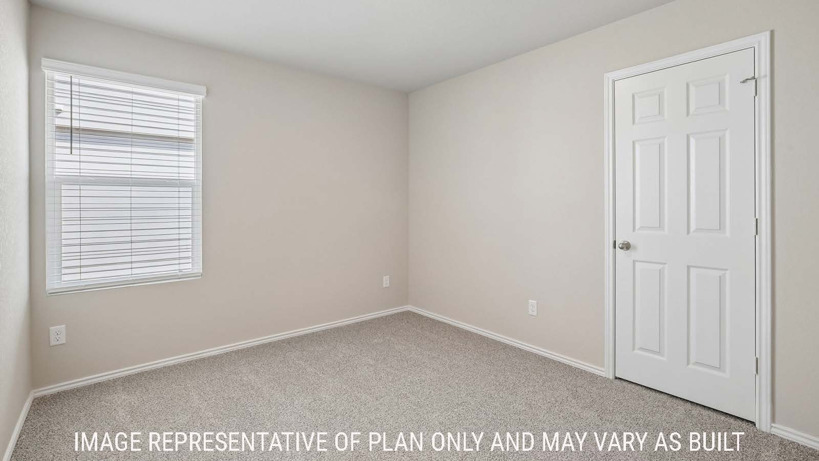 Archer secondary bedroom with carpeted flooring and window for natural lighting.
