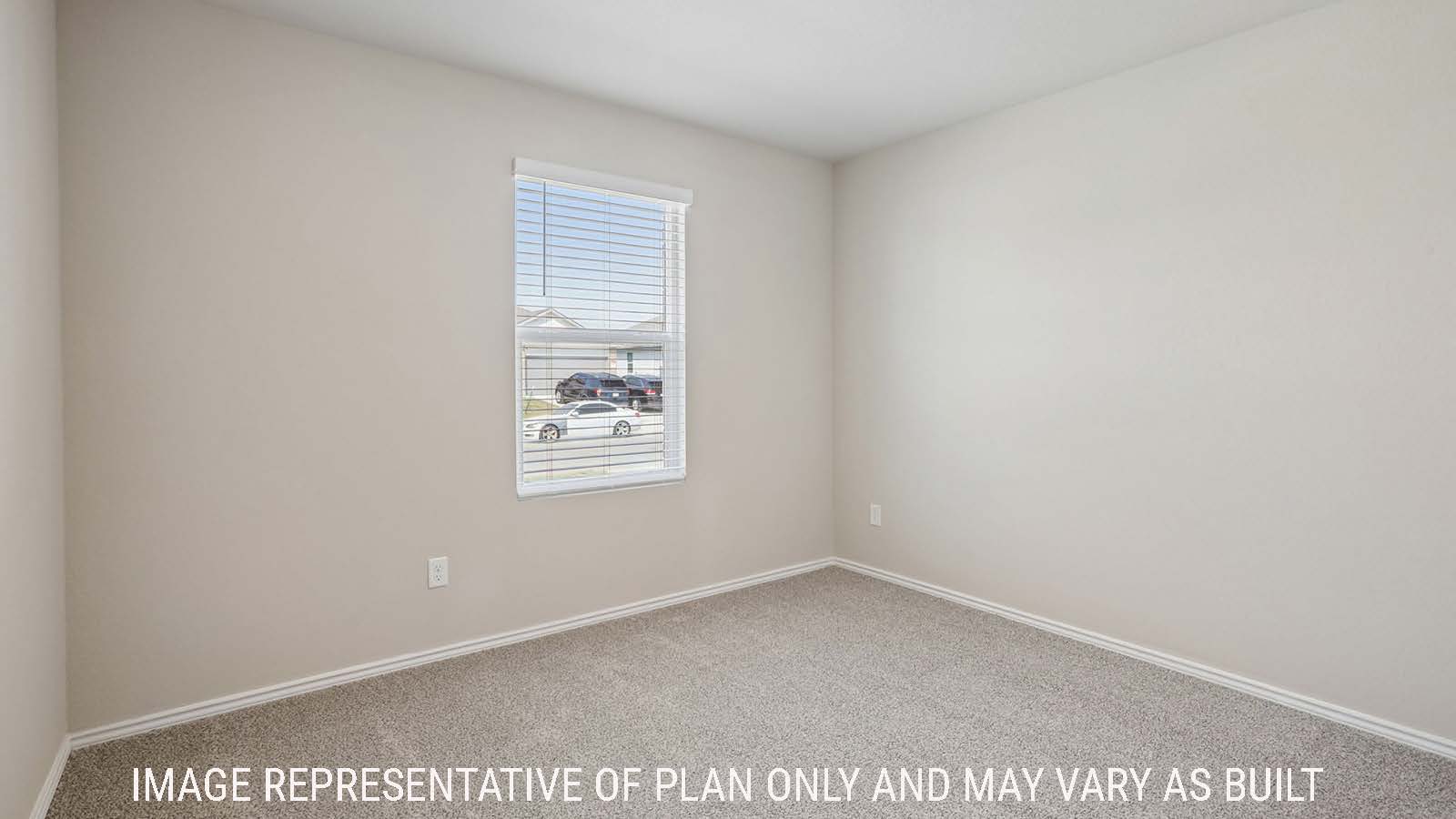 Archer secondary bedroom with carpeted flooring and window for natural lighting.