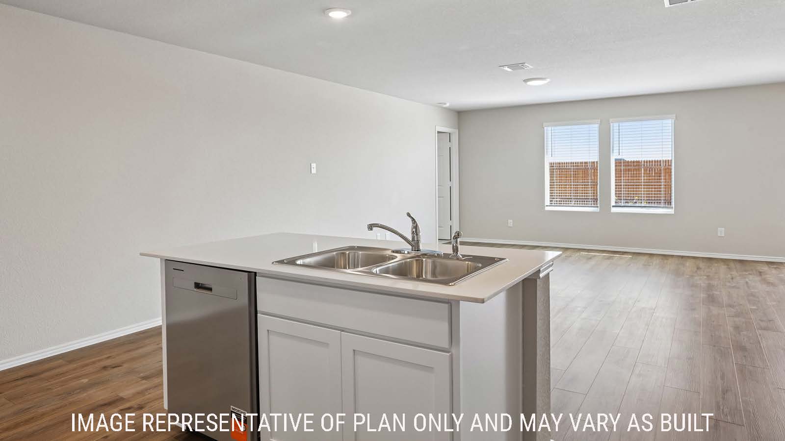 Archer kitchen with kitchen island and view of open concept dining room and living room.