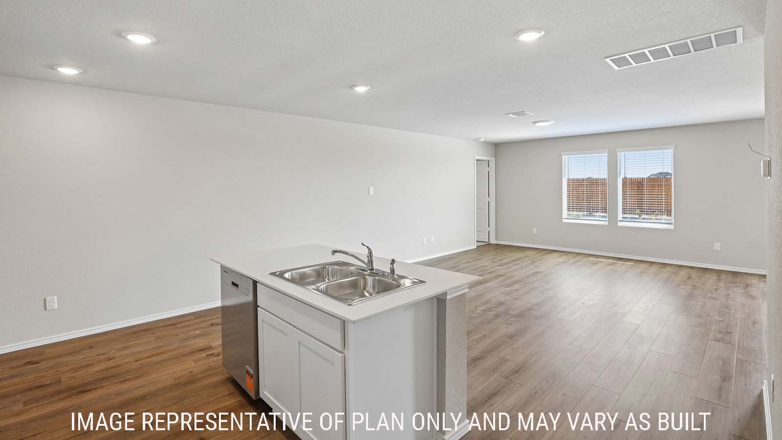 Archer kitchen with kitchen island and view of open concept dining room and living room.