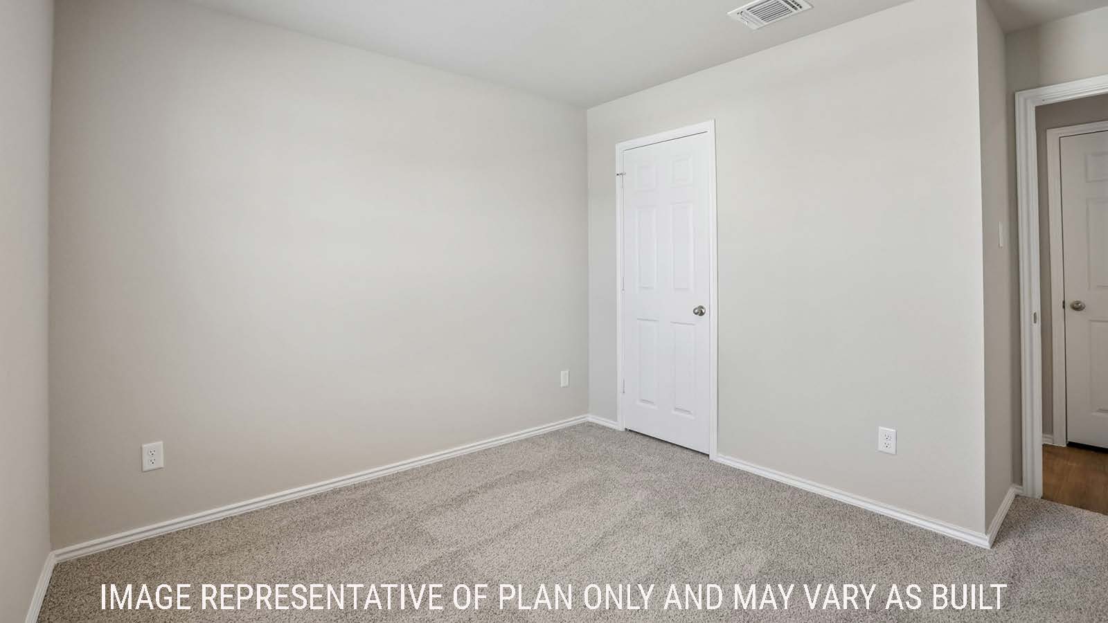 Archer secondary bedroom with carpeted flooring and view of hallway.