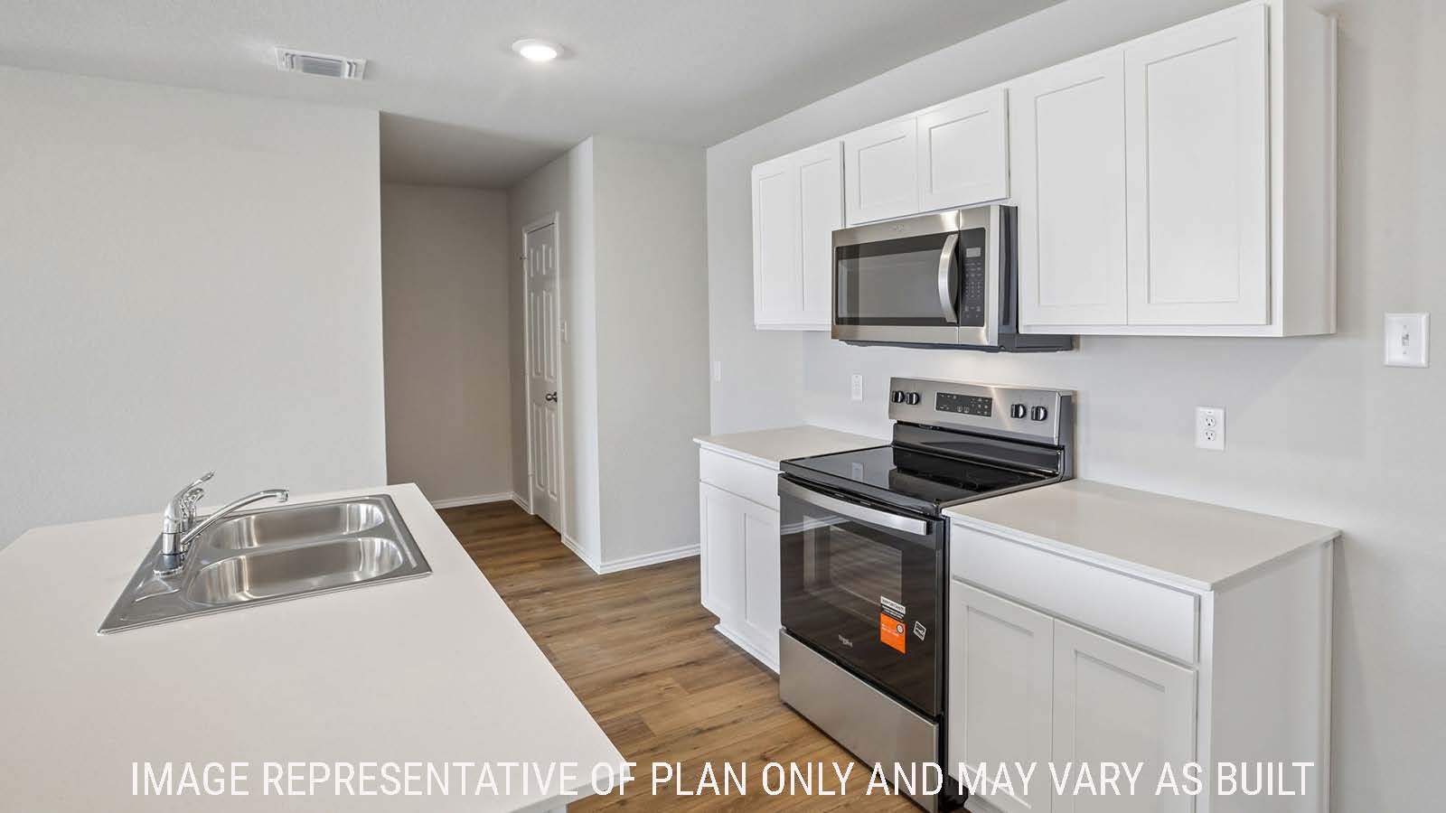 Archer kitchen with kitchen island with light cabinets and granite countertops.