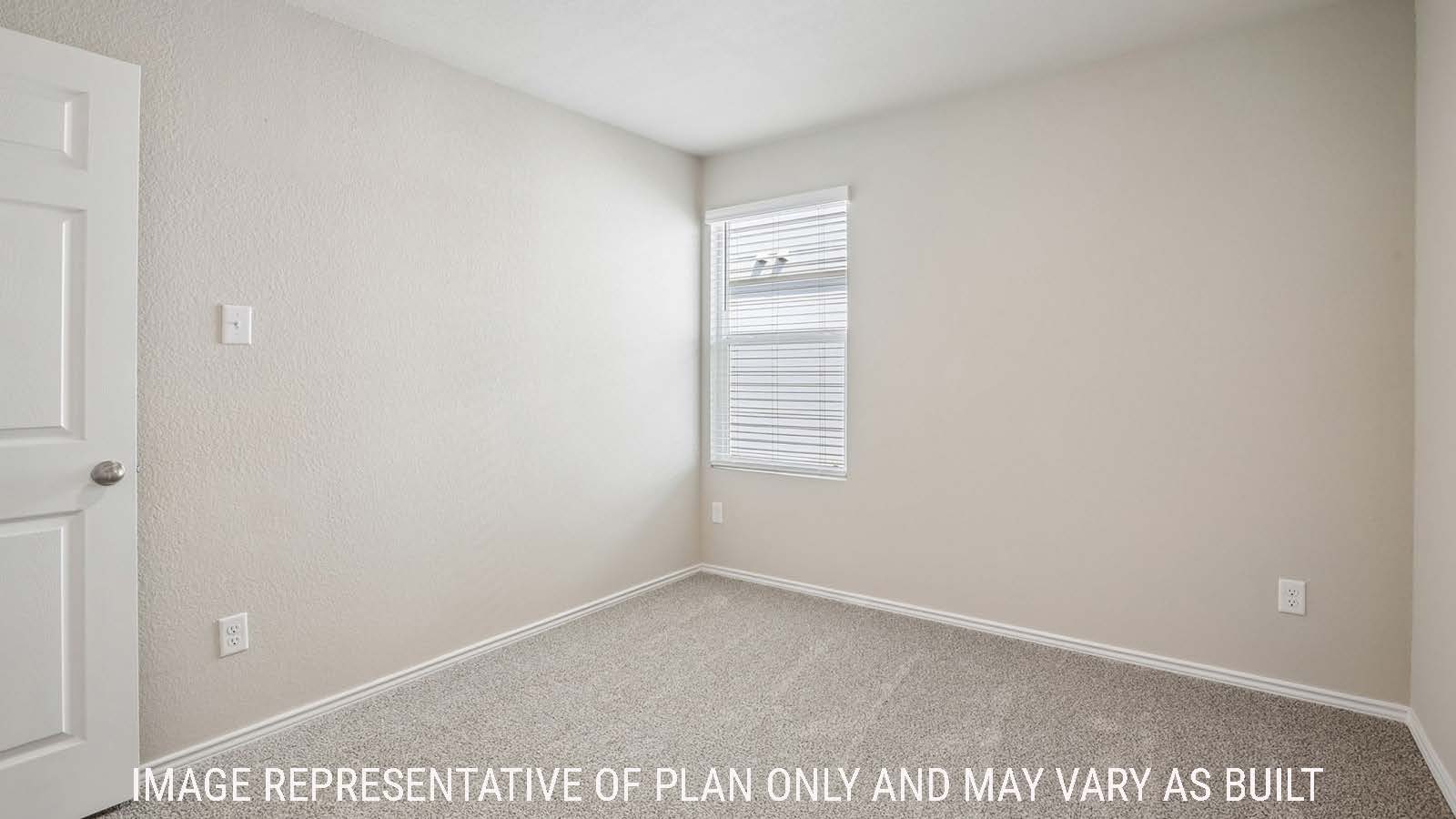 Archer secondary bedroom with carpeted flooring and window for natural lighting.