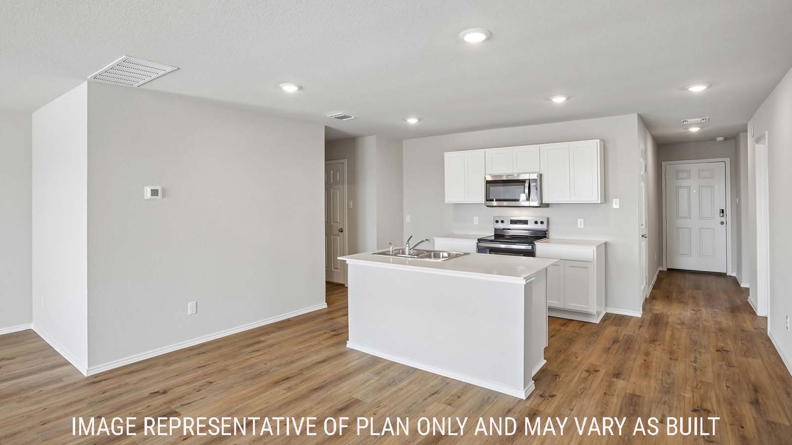 Archer kitchen with view of kitchen island with light cabinets and view of front entry way.