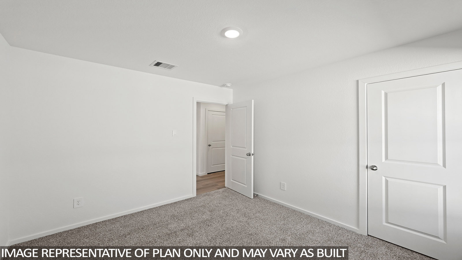 Bradley secondary bedroom with carpeted flooring and view of hallway.